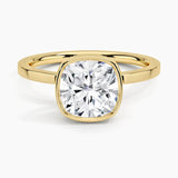 alt="An Cushion cut Moissanite engagement ring with a bezel setting, displayed on a gold band, against a white background.Moissanite engagement ring cape town south africa grand diamonds ralph jacobs jeulia "