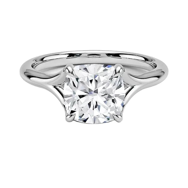Engagement ring Cushion cut Moissanite lab grown diamond engagement ring v-Split round shank with a four cat-claw setting, on a gold band, against a white background.Moissanite engagement ring cape town south africa grand diamonds ralph jacobs jeulia 