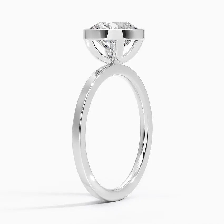 alt="An Cushion cut Moissanite engagement ring with a bezel setting, displayed on a gold band, against a white background.Moissanite engagement ring cape town south africa grand diamonds ralph jacobs jeulia "