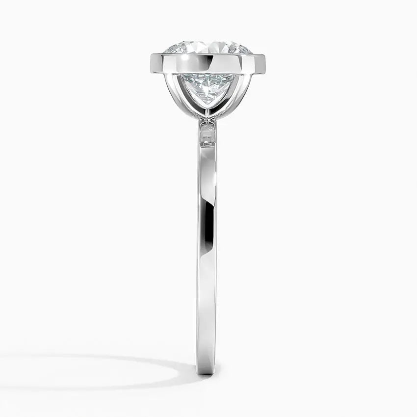 alt="An Cushion cut Moissanite engagement ring with a bezel setting, displayed on a gold band, against a white background.Moissanite engagement ring cape town south africa grand diamonds ralph jacobs jeulia "