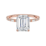 Emerald cut Moissanite lab grown diamond engagement ring with fancy baguette and round cut moissanite set pave gold band, against a white background.Moissanite engagement ring cape town south africa grand diamonds ralph jacobs jeulia 