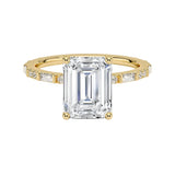 Emerald cut Moissanite lab grown diamond engagement ring with fancy baguette and round cut moissanite set pave gold band, against a white background.Moissanite engagement ring cape town south africa grand diamonds ralph jacobs jeulia 