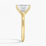 Emerald  cut Moissanite lab grown diamond engagement ring V-split band  with a four claw setting, on a gold band, against a white background.Moissanite engagement ring cape town south africa grand diamonds ralph jacobs jeulia  