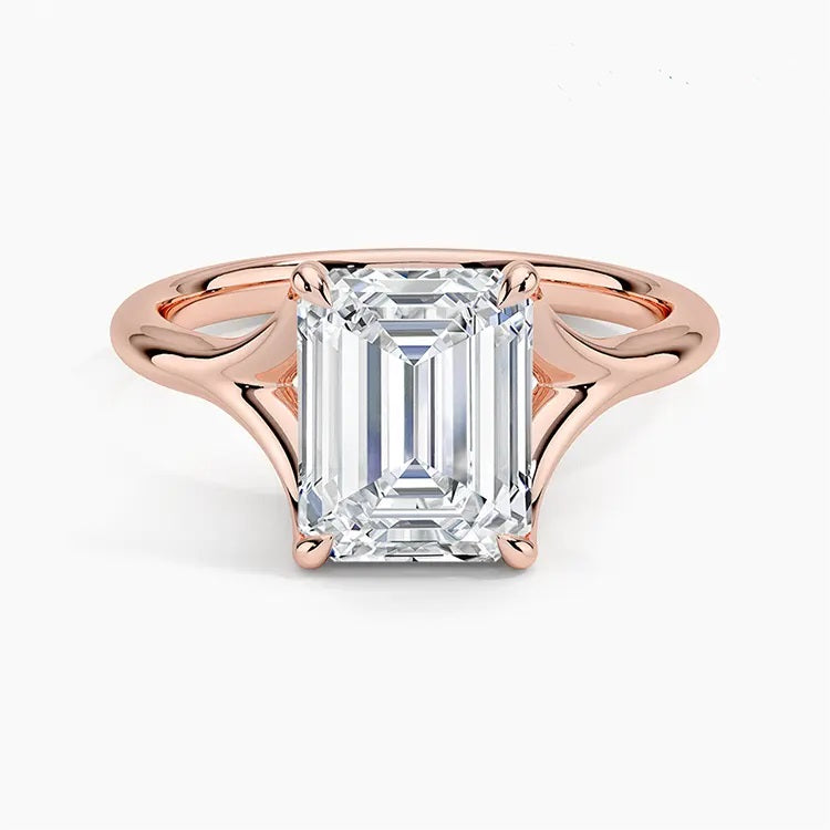 Emerald  cut Moissanite lab grown diamond engagement ring V-split band  with a four claw setting, on a gold band, against a white background.Moissanite engagement ring cape town south africa grand diamonds ralph jacobs jeulia  