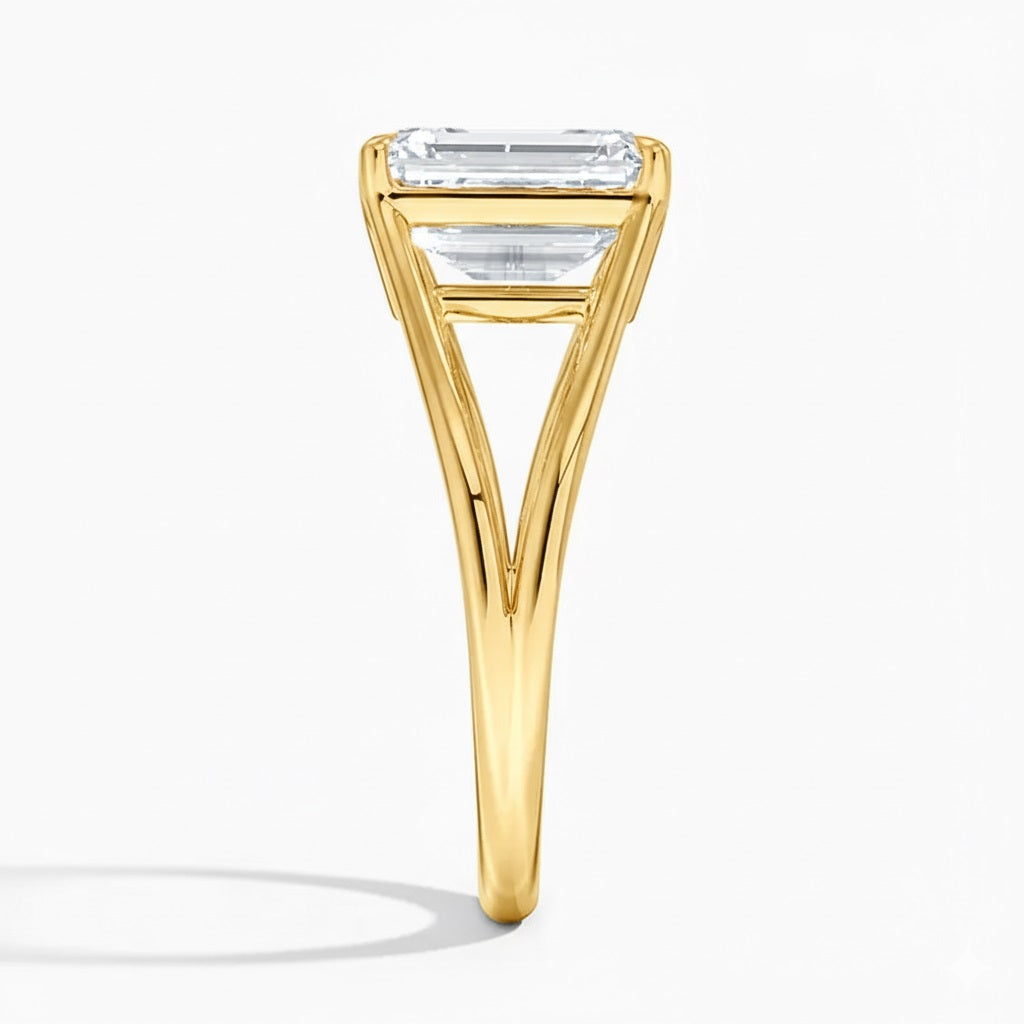 Emerald cut Moissanite lab grown diamond engagement ring round shank with a four claw setting, on a gold band, against a white background.Moissanite engagement ring cape town south africa grand diamonds ralph jacobs jeulia 