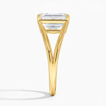 Emerald cut Moissanite lab grown diamond engagement ring round shank with a four claw setting, on a gold band, against a white background.Moissanite engagement ring cape town south africa grand diamonds ralph jacobs jeulia 