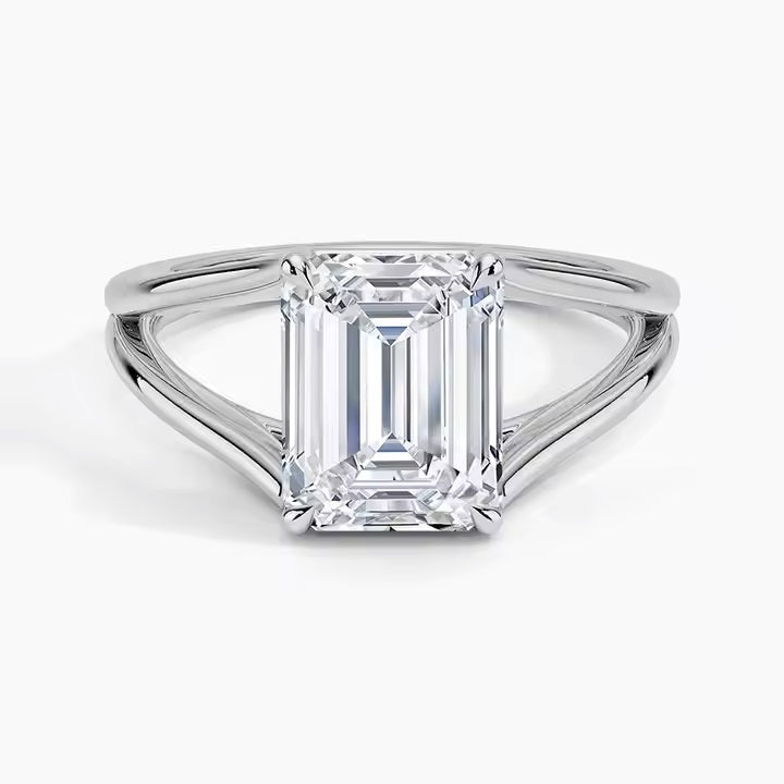Emerald cut Moissanite lab grown diamond engagement ring round shank with a four claw setting, on a gold band, against a white background.Moissanite engagement ring cape town south africa grand diamonds ralph jacobs jeulia 