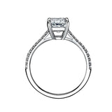 Emerald cut Moissanite lab grown diamond engagement ring pave set shank with a four claw setting, on a gold band, against a white background.Moissanite engagement ring cape town south africa grand diamonds ralph jacobs jeulia 