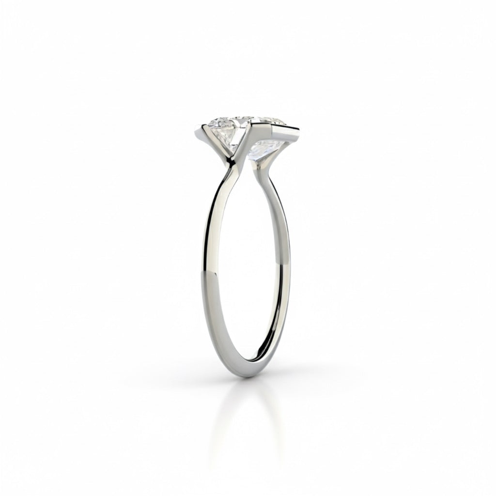 Emerald cut Moissanite lab grown diamond engagement ring column clean sophisticated design on a gold band, against a white background.Moissanite engagement ring cape town south africa grand diamonds ralph jacobs jeuli