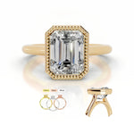 alt="An Emarald cut Moissanite engagement ring round shank with a bezel setting, on a gold band, against a white background.Moissanite engagement ring cape town south africa grand diamonds ralph jacobs jeulia 