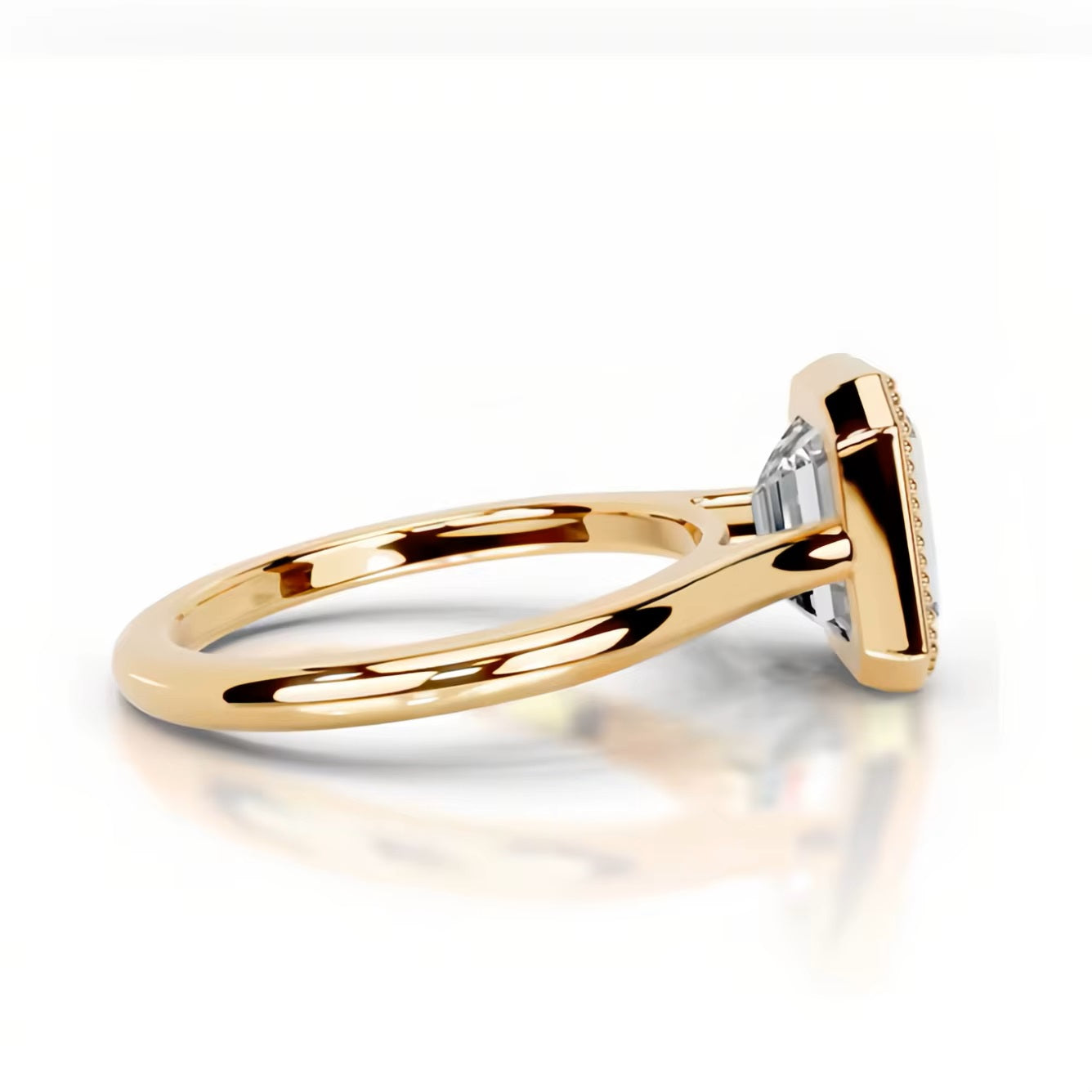 alt="An Emarald cut Moissanite engagement ring round shank with a bezel setting, on a gold band, against a white background.Moissanite engagement ring cape town south africa grand diamonds ralph jacobs jeulia lab grown diamond "