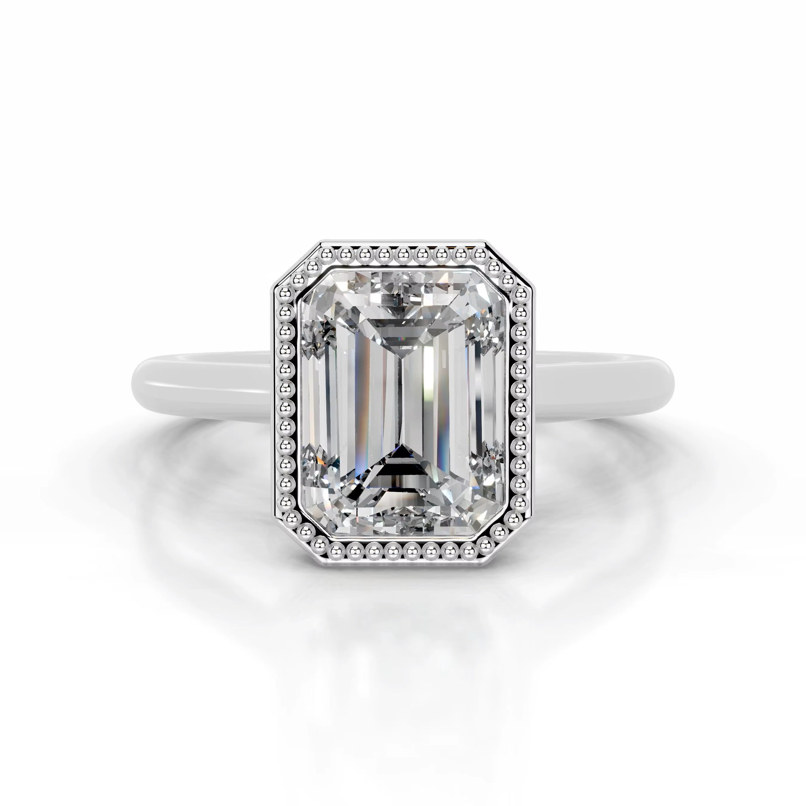 alt="An Emarald cut Moissanite engagement ring round shank with a bezel setting, on a gold band, against a white background.Moissanite engagement ring cape town south africa grand diamonds ralph jacobs jeulia 