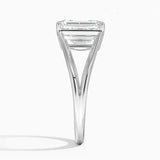 Emerald cut Moissanite lab grown diamond engagement ring round shank with a four claw setting, on a gold band, against a white background.Moissanite engagement ring cape town south africa grand diamonds ralph jacobs jeulia 