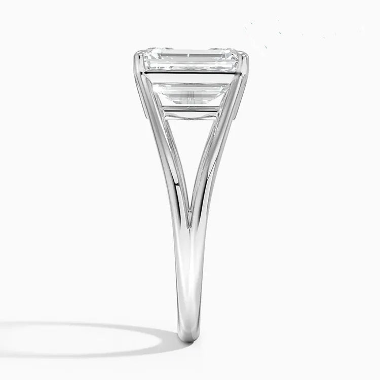 Emerald cut Moissanite lab grown diamond engagement ring round shank with a four claw setting, on a gold band, against a white background.Moissanite engagement ring cape town south africa grand diamonds ralph jacobs jeulia 