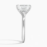 Emerald  cut Moissanite lab grown diamond engagement ring V-split band  with a four claw setting, on a gold band, against a white background.Moissanite engagement ring cape town south africa grand diamonds ralph jacobs jeulia  