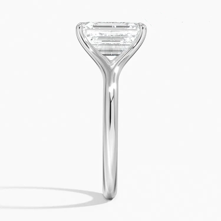 Emerald  cut Moissanite lab grown diamond engagement ring V-split band  with a four claw setting, on a gold band, against a white background.Moissanite engagement ring cape town south africa grand diamonds ralph jacobs jeulia  