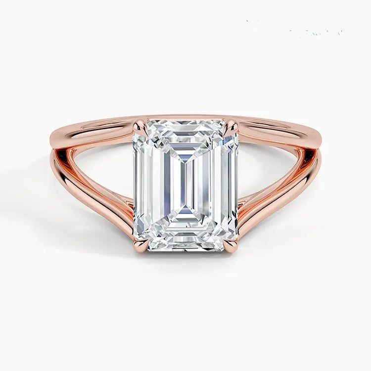 Emerald cut Moissanite lab grown diamond engagement ring round shank with a four claw setting, on a gold band, against a white background.Moissanite engagement ring cape town south africa grand diamonds ralph jacobs jeulia 