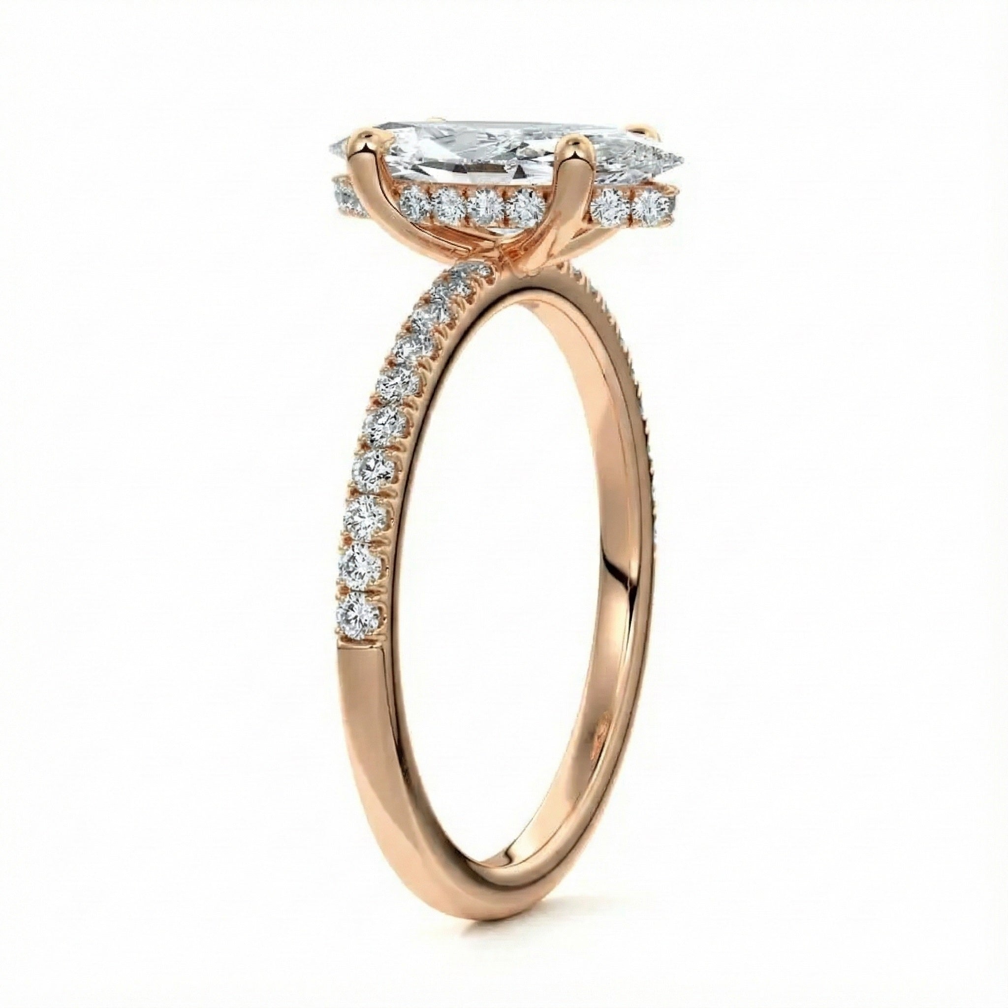 Marquise cut Moissanite lab grown diamond engagement ring round shank with four cat claw setting hidden halo and pave set shank, on a gold band, against a white background.Moissanite engagement ring cape town south africa grand diamonds ralph jacobs jeulia 