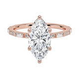 Marquise cut Moissanite lab grown diamond engagement ring with baguette and round moissanite's pave set shank with classic four prong setting, on a gold band, against a white background.Moissanite engagement ring cape town south africa grand diamonds ralph jacobs jeulia 