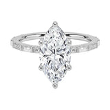 Marquise cut Moissanite lab grown diamond engagement ring with baguette and round moissanite's pave set shank with classic four prong setting, on a gold band, against a white background.Moissanite engagement ring cape town south africa grand diamonds ralph jacobs jeulia 