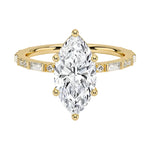 Marquise cut Moissanite lab grown diamond engagement ring with baguette and round moissanite's pave set shank with classic four prong setting, on a gold band, against a white background.Moissanite engagement ring cape town south africa grand diamonds ralph jacobs jeulia 