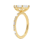 Marquise cut Moissanite lab grown diamond engagement ring with baguette and round moissanite's pave set shank with classic four prong setting, on a gold band, against a white background.Moissanite engagement ring cape town south africa grand diamonds ralph jacobs jeulia 