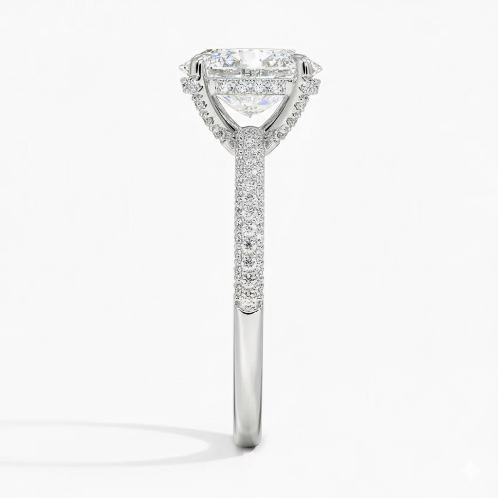 Oval cut Moissanite lab grown diamond engagement ring with three row micro pave set gold shank, hidden halo and encrusted claws against a white background.Moissanite engagement ring cape town south africa grand diamonds ralph jacobs jeulia 