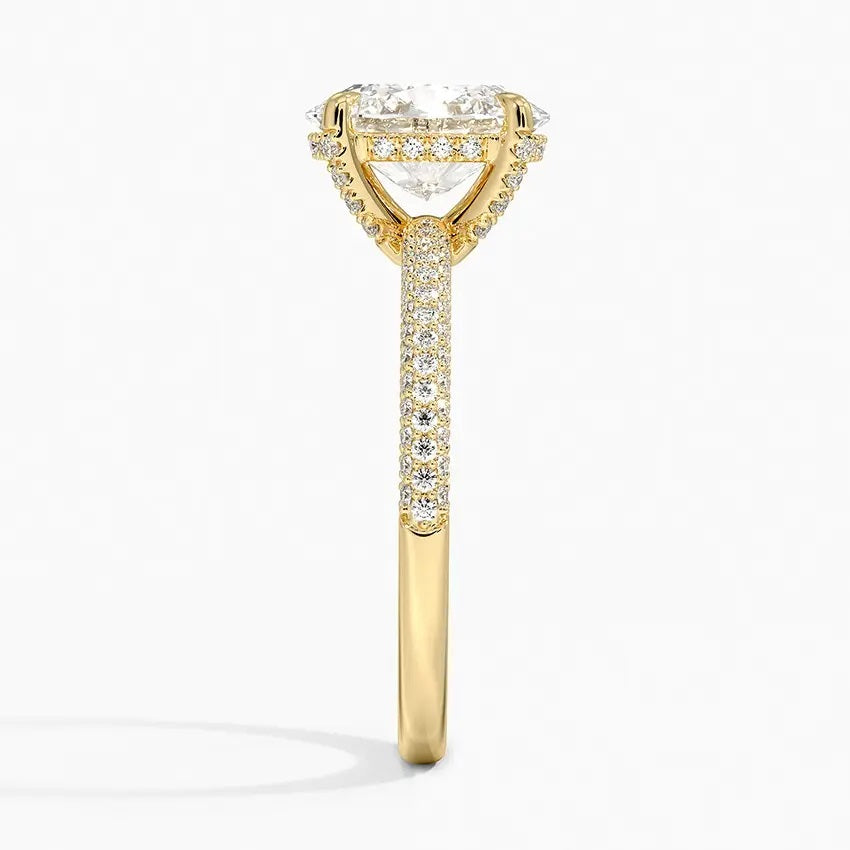 Oval cut Moissanite lab grown diamond engagement ring with three row micro pave set gold shank, hidden halo and encrusted claws against a white background.Moissanite engagement ring cape town south africa grand diamonds ralph jacobs jeulia 