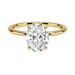 a Oval cut Moissanite lab grown diamond engagement ring round shank with a four claw setting, on a gold band, against a white background.Moissanite engagement ring cape town south africa grand diamonds ralph jacobs jeuli