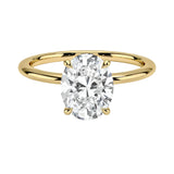 a Oval cut Moissanite lab grown diamond engagement ring round shank with a four claw setting, on a gold band, against a white background.Moissanite engagement ring cape town south africa grand diamonds ralph jacobs jeuli
