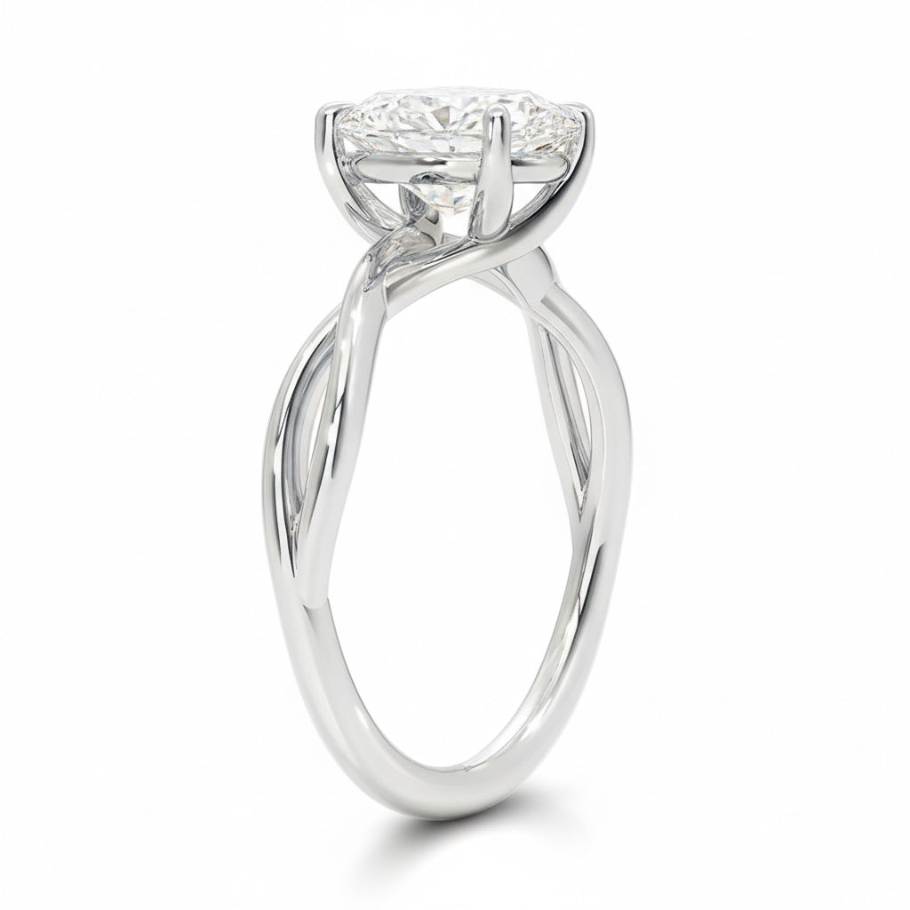 Oval cut Moissanite lab grown diamond engagement ring twisted shank with a four cat-claw setting, on a gold band, against a white background.Moissanite engagement ring cape town south africa grand diamonds ralph jacobs jeuli