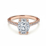 Oval cut Moissanite lab grown diamond engagement ring pave set shank with a four claw setting, on a gold band, against a white background.Moissanite engagement ring cape town south africa grand diamonds ralph jacobs jeulia