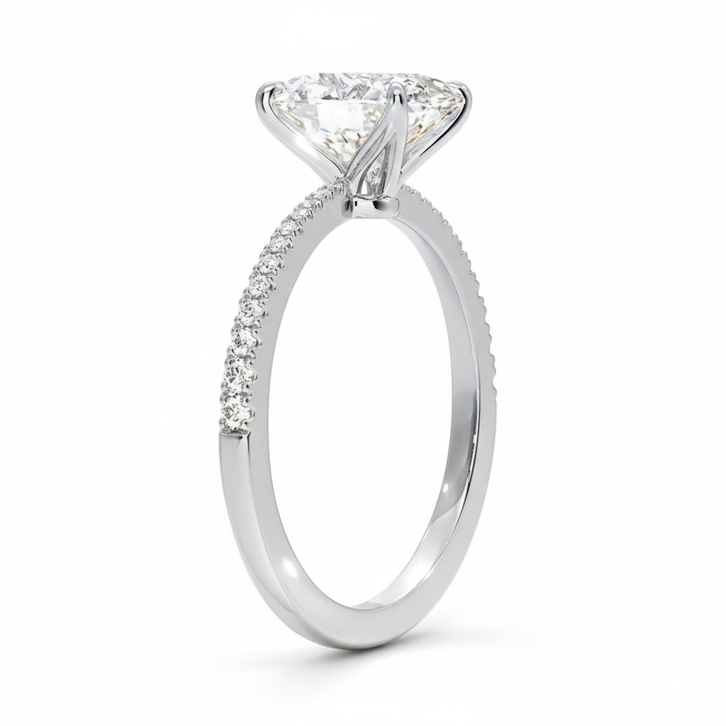 Oval cut Moissanite lab grown diamond engagement ring with tapered pave set shank on a gold band, against a white background.Moissanite engagement ring cape town south africa grand diamonds ralph jacobs jeulia 