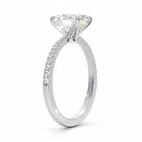 Oval cut Moissanite lab grown diamond engagement ring with tapered pave set shank on a gold band, against a white background.Moissanite engagement ring cape town south africa grand diamonds ralph jacobs jeulia 