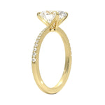 Oval cut Moissanite lab grown diamond engagement ring with tapered pave set shank on a gold band, against a white background.Moissanite engagement ring cape town south africa grand diamonds ralph jacobs jeulia 