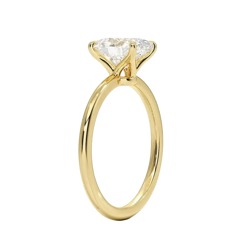 Oval cut Moissanite lab grown diamond engagement ring round shank with pin claw setting, on a gold band, against a white background.Moissanite engagement ring cape town south africa grand diamonds ralph jacobs jeulia 