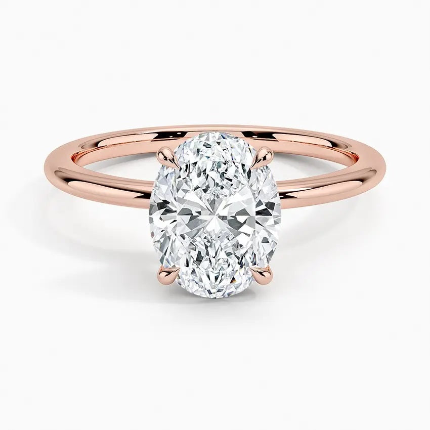 Oval cut Moissanite lab grown diamond engagement ring round shank with a four claw setting, on a gold band, against a white background.Moissanite engagement ring cape town south africa grand diamonds ralph jacobs jeuli