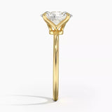 Oval cut Moissanite lab grown diamond engagement ring round shank with a four claw setting, on a gold band, against a white background.Moissanite engagement ring cape town south africa grand diamonds ralph jacobs jeuli
