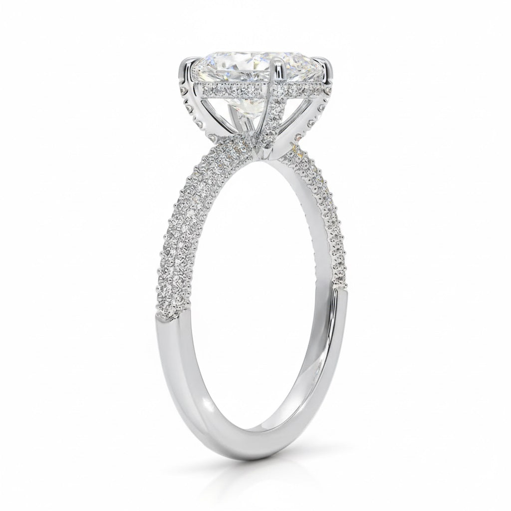 Oval cut Moissanite lab grown diamond engagement ring with three row micro pave set gold shank, hidden halo and encrusted claws against a white background.Moissanite engagement ring cape town south africa grand diamonds ralph jacobs jeulia 