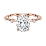 Oval cut Moissanite lab grown diamond engagement ring with tube set small round moissanites on the shank, on a gold band, against a white background.Moissanite engagement ring cape town south africa grand diamonds ralph jacobs jeulia 