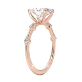 Oval cut Moissanite lab grown diamond engagement ring with tube set small round moissanites on the shank, on a gold band, against a white background.Moissanite engagement ring cape town south africa grand diamonds ralph jacobs jeulia 