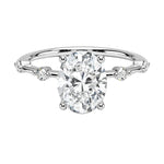 Oval cut Moissanite lab grown diamond engagement ring with tube set small round moissanites on the shank, on a gold band, against a white background.Moissanite engagement ring cape town south africa grand diamonds ralph jacobs jeulia 