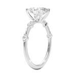 Oval cut Moissanite lab grown diamond engagement ring with tube set small round moissanites on the shank, on a gold band, against a white background.Moissanite engagement ring cape town south africa grand diamonds ralph jacobs jeulia 