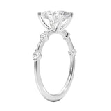 Oval cut Moissanite lab grown diamond engagement ring with tube set small round moissanites on the shank, on a gold band, against a white background.Moissanite engagement ring cape town south africa grand diamonds ralph jacobs jeulia 