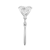 Oval cut Moissanite lab grown diamond engagement ring with tube set small round moissanites on the shank, on a gold band, against a white background.Moissanite engagement ring cape town south africa grand diamonds ralph jacobs jeulia 