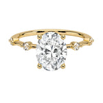 Oval cut Moissanite lab grown diamond engagement ring with tube set small round moissanites on the shank, on a gold band, against a white background.Moissanite engagement ring cape town south africa grand diamonds ralph jacobs jeulia 