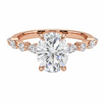 Oval cut Moissanite lab grown diamond engagement ring with tube set small round moissanites on the shank, on a gold band, against a white background.Moissanite engagement ring cape town south africa grand diamonds ralph jacobs jeulia 