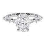 Oval cut Moissanite lab grown diamond engagement ring with tube set small round moissanites on the shank, on a gold band, against a white background.Moissanite engagement ring cape town south africa grand diamonds ralph jacobs jeulia 