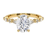 Oval cut Moissanite lab grown diamond engagement ring with tube set small round moissanites on the shank, on a gold band, against a white background.Moissanite engagement ring cape town south africa grand diamonds ralph jacobs jeulia 