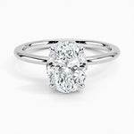 Oval cut Moissanite lab grown diamond engagement ring round shank with a four claw setting, on a gold band, against a white background.Moissanite engagement ring cape town south africa grand diamonds ralph jacobs jeuli